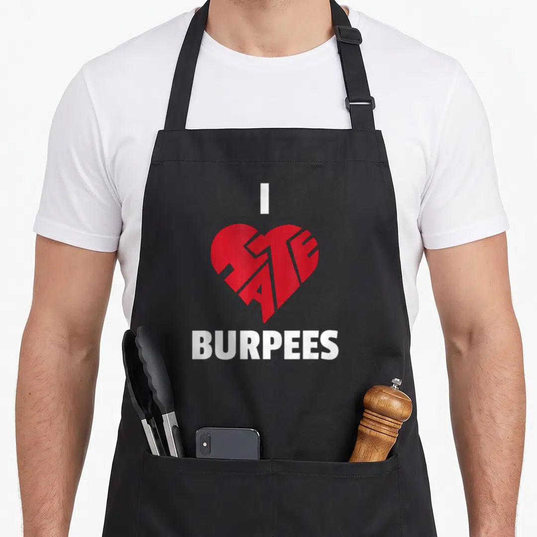 Exercise hate burpees apron - Red heart with HATE cutout and white I BURPEES text — shown on a black cotton canvas apron against a white background
