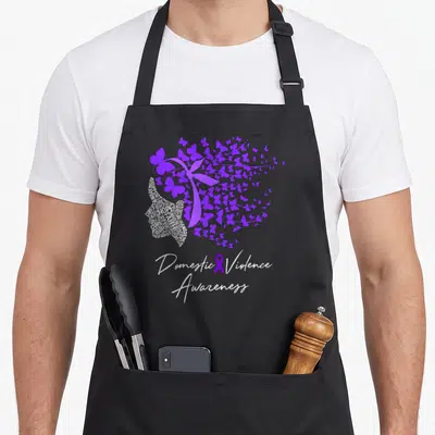 Awareness butterfly domestic aprons - Purple ribbon word cloud dissolving into butterflies with white script text below — shown on a black cotton canvas apron against a white background