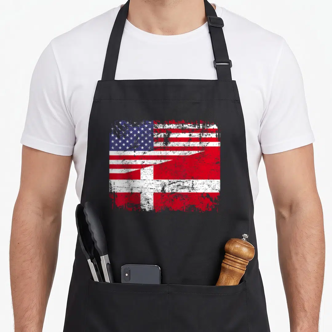 Danish american flag apron - Distressed merged US and Danish flags in red white blue diagonal layout — shown on a black cotton canvas apron against a white background