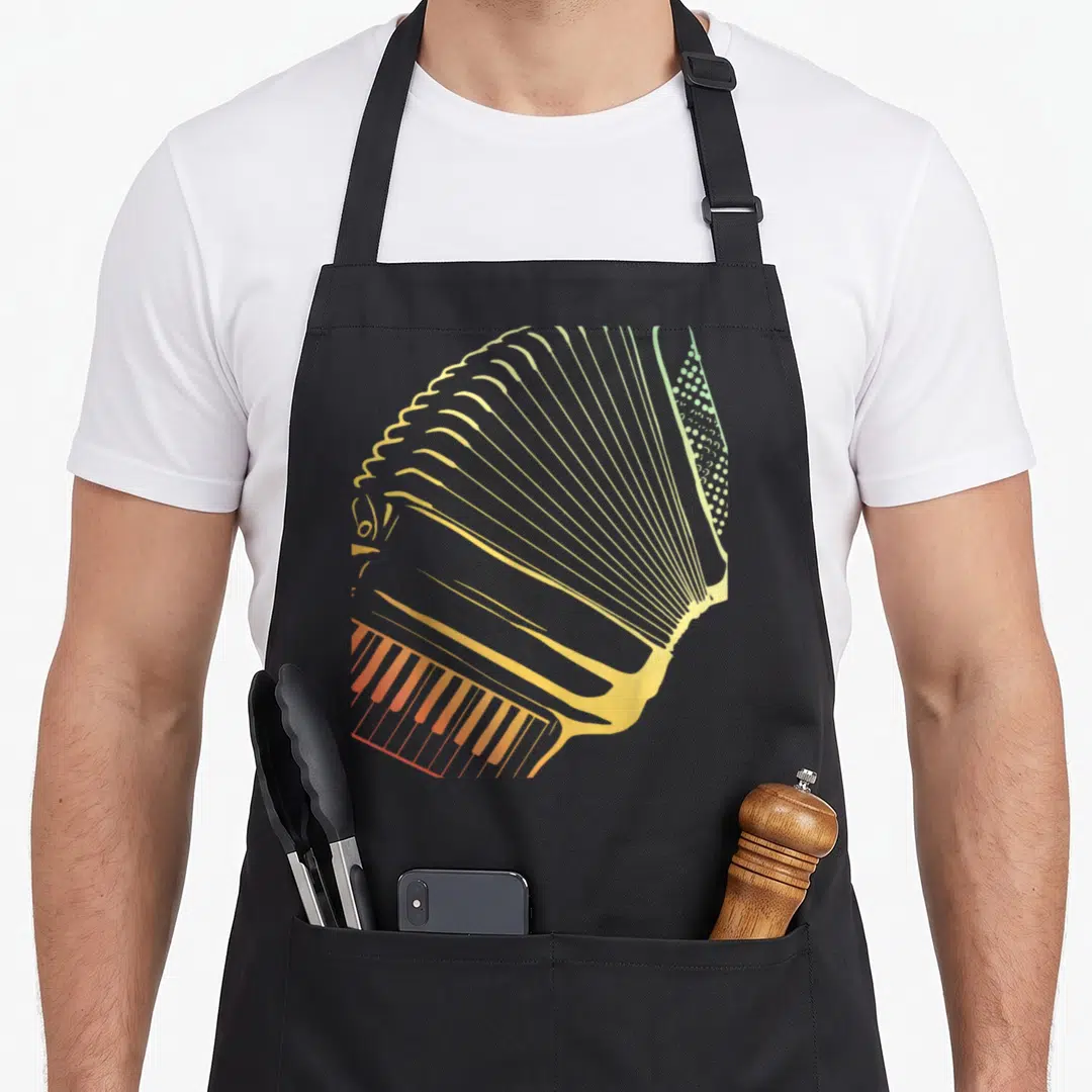 Retro air accordion apron - Minimalist accordion graphic in orange yellow and green gradient showing bellows and keys — shown on a black cotton canvas apron against a white background
