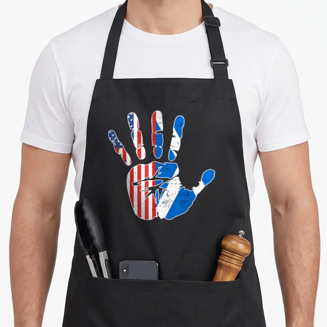 Handprint american flag apron - Distressed handprint filled with USA and Puerto Rican flag patterns in red white — shown on a black cotton canvas apron against a white background