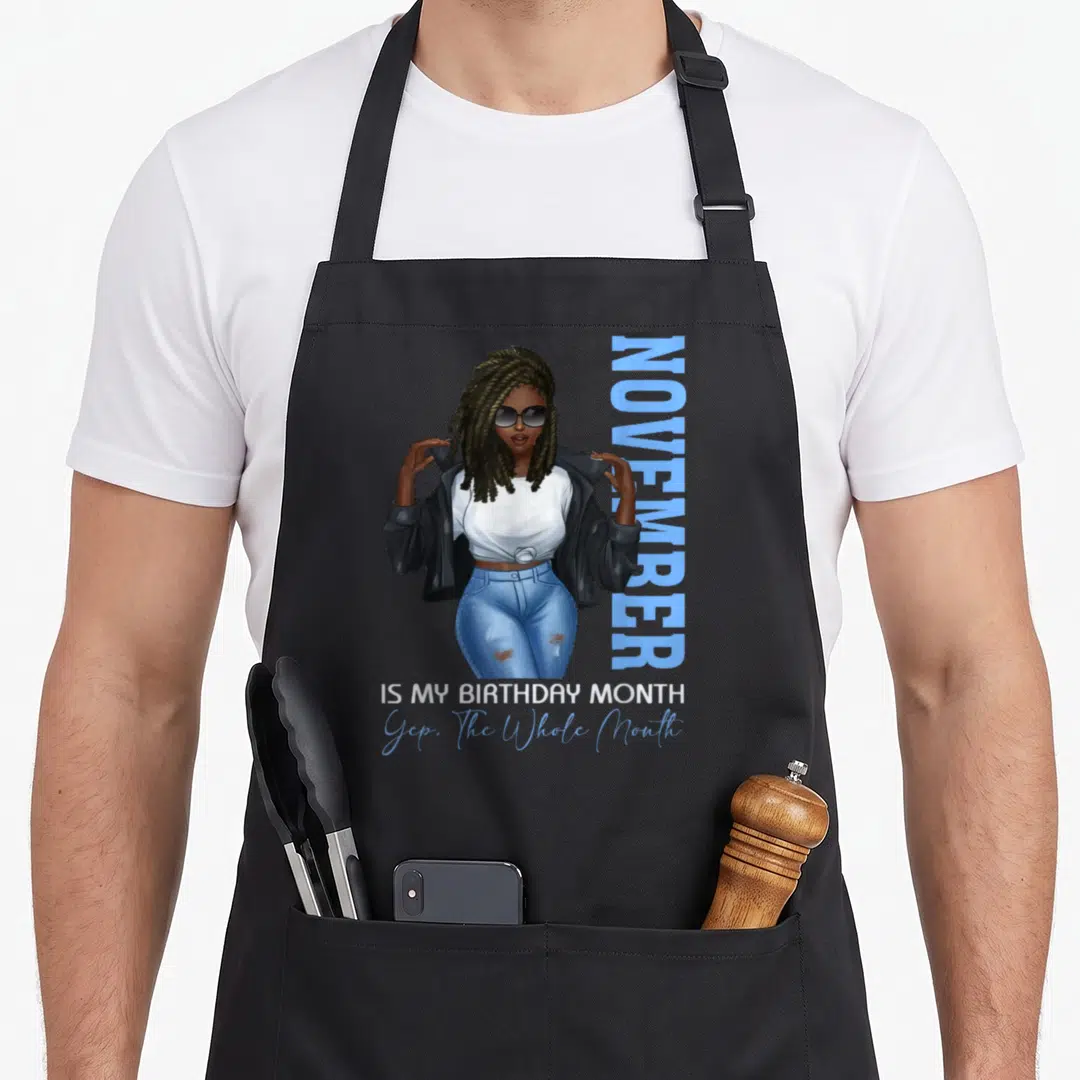 Month november birthday apron - Woman in sunglasses with text November is my birthday monthYep The Whole Month — shown on a black cotton canvas apron against a white background