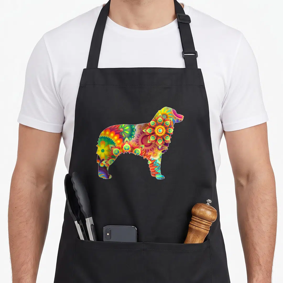 Colorful australian aprons - Dog silhouette filled with colorful yellow orange blue purple green patterns — shown on a black cotton canvas apron against a white background