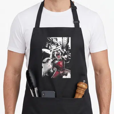 Roar arugula apron - Screaming raccoon in armor with red splatters and gun in distressed white grey and red — shown on a black cotton canvas apron against a white background