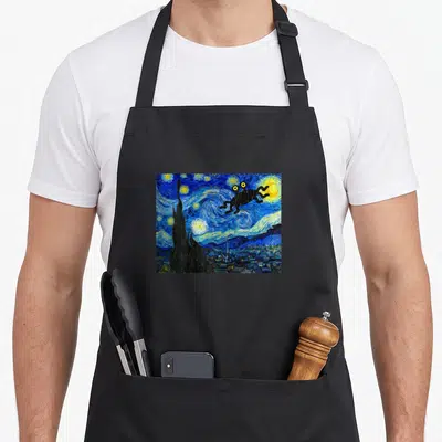 Fsm flying apron - Black frog silhouette superimposed over blue and yellow Starry Night painting swirls — shown on a black cotton canvas apron against a white background