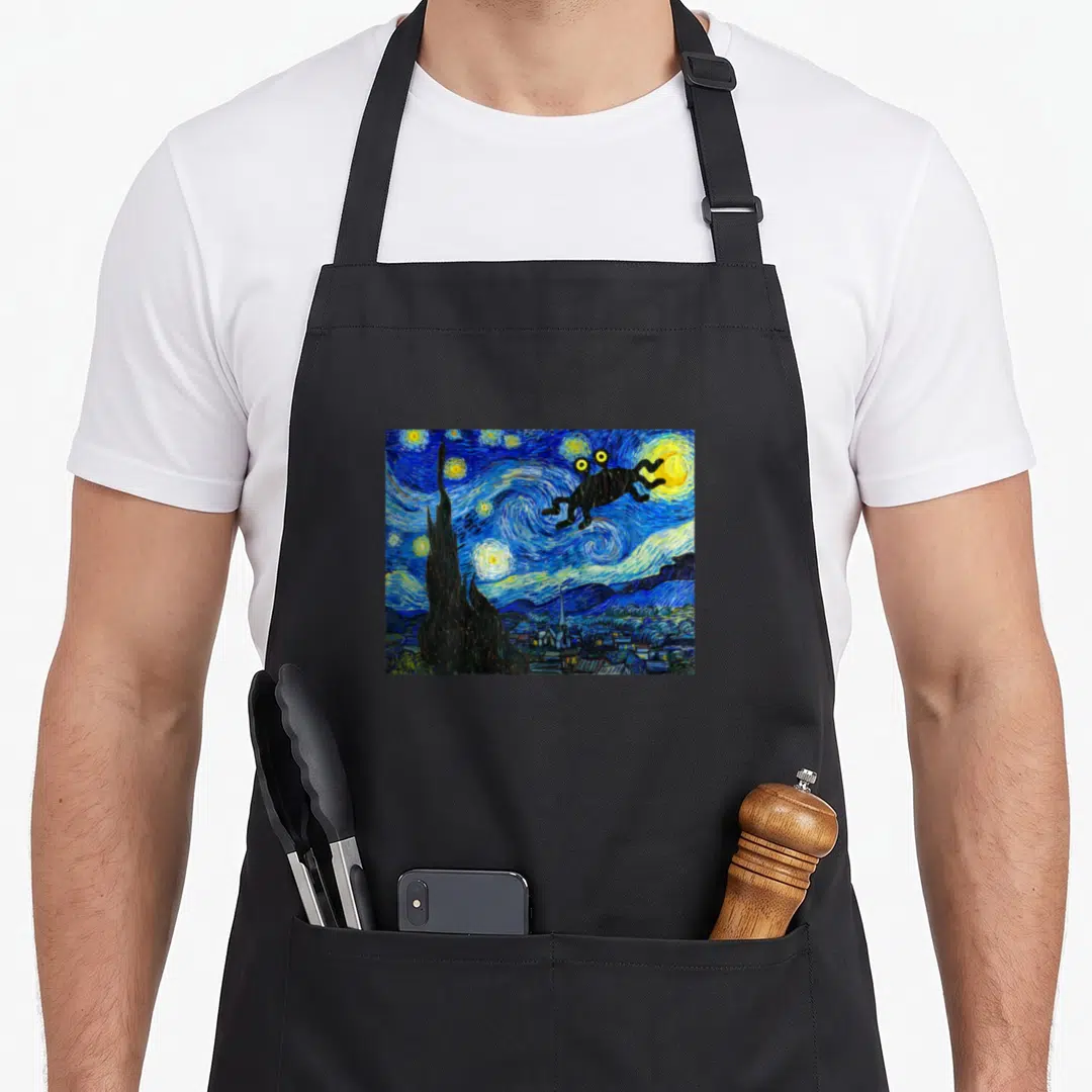 Fsm flying apron - Black frog silhouette superimposed over blue and yellow Starry Night painting swirls — shown on a black cotton canvas apron against a white background