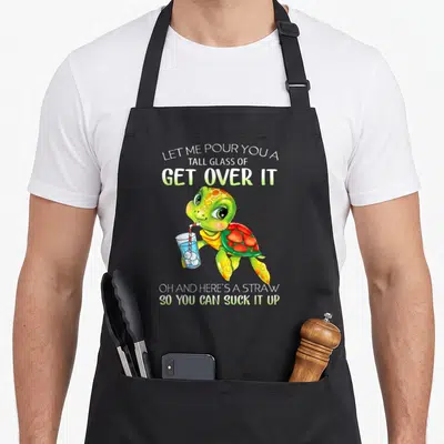 Pour glass apron - Cartoon turtle holding blue drink with sarcastic get over it text — shown on a black cotton canvas apron against a white background