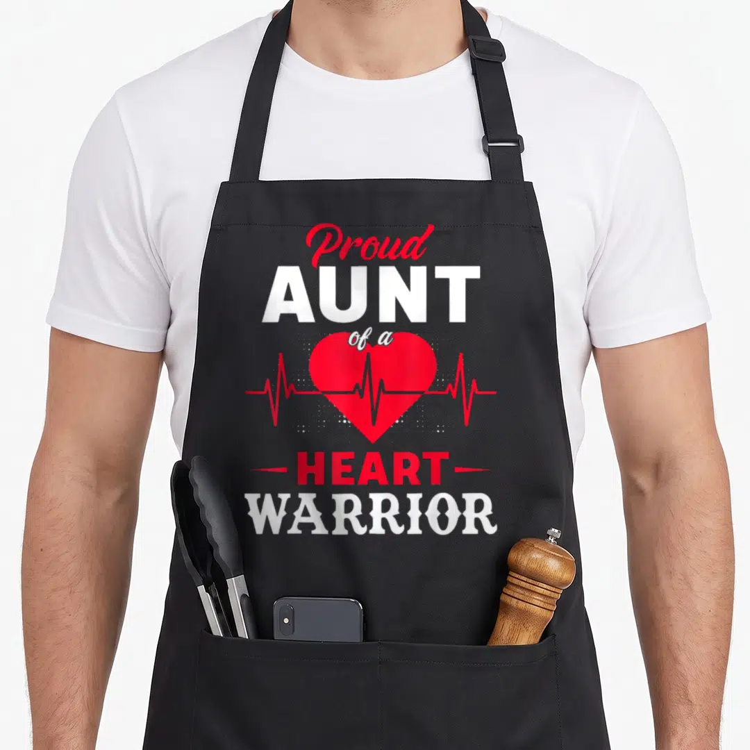 Aunt warrior chd congenital heart defect apron - Red heart with heartbeat line and Proud AUNT of a HEART WARRIOR text — shown on a black cotton canvas apron against a white background