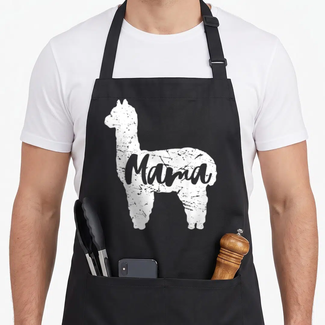Proud alpaca apron - White llama silhouette with grey Mama text inside the body shape — shown on a black cotton canvas apron against a white background