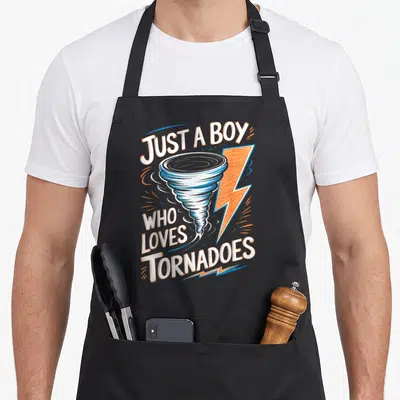 Tornado storm meteorologist apron - Cartoon tornado and lightning bolt with white and orange text reading Just a Boy — shown on a black cotton canvas apron against a white background