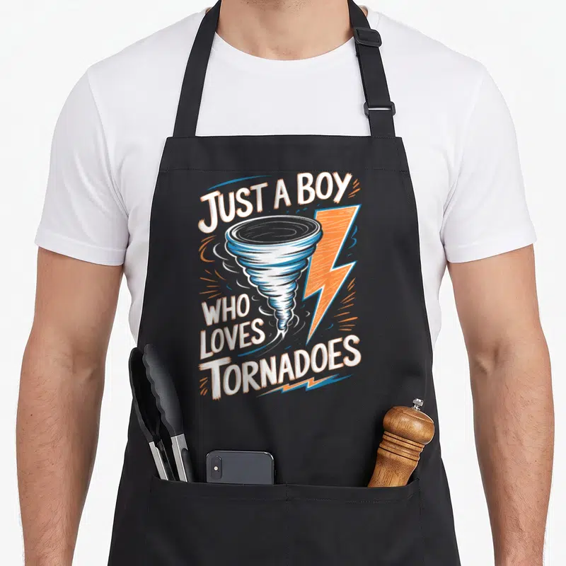 Tornado storm meteorologist apron - Cartoon tornado and lightning bolt with white and orange text reading Just a Boy — shown on a black cotton canvas apron against a white background
