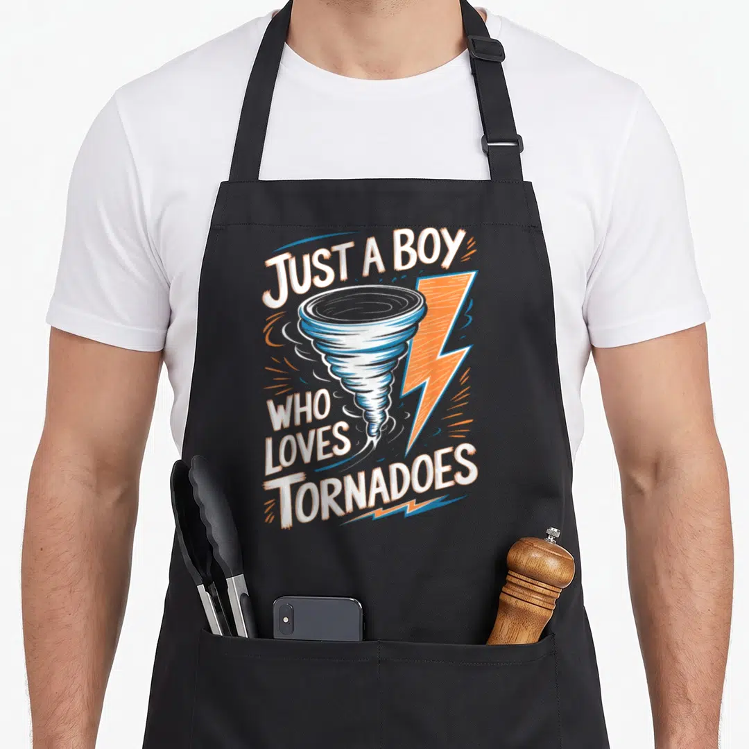 Tornado storm meteorologist apron - Cartoon tornado and lightning bolt with white and orange text reading Just a Boy — shown on a black cotton canvas apron against a white background