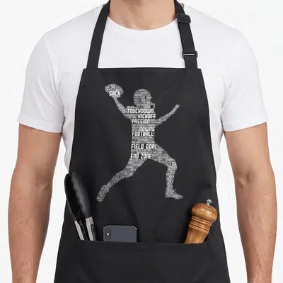 Player football apron for women - White word cloud forming football player silhouette using terms like sack — shown on a black cotton canvas apron against a white background
