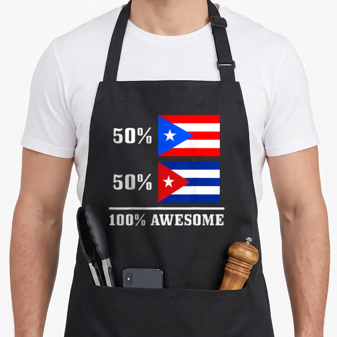 Rico cuba pride apron - Stacked Puerto Rican and Cuban flags beside 50% text above 100% Awesome label — shown on a black cotton canvas apron against a white background