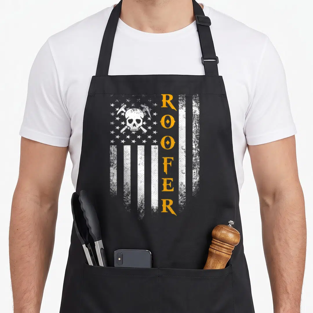 Roofer patriotic american flag apron - Distressed white flag with vertical orange ROOFER text and white skull — shown on a black cotton canvas apron against a white background