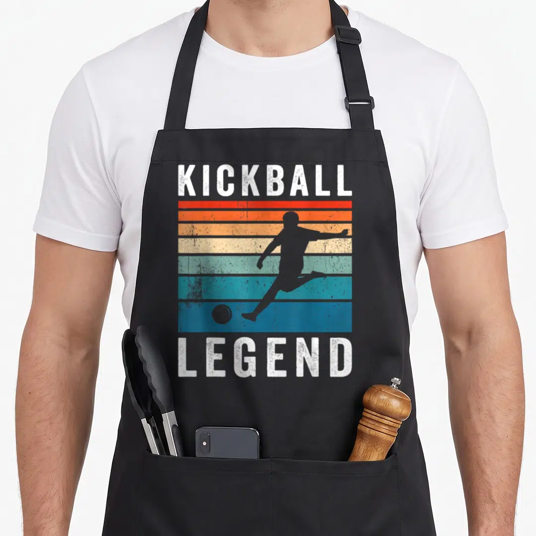 Legend kickball apron - KICKBALL LEGEND text with player silhouette over red orange yellow blue white stripes — shown on a black cotton canvas apron against a white background
