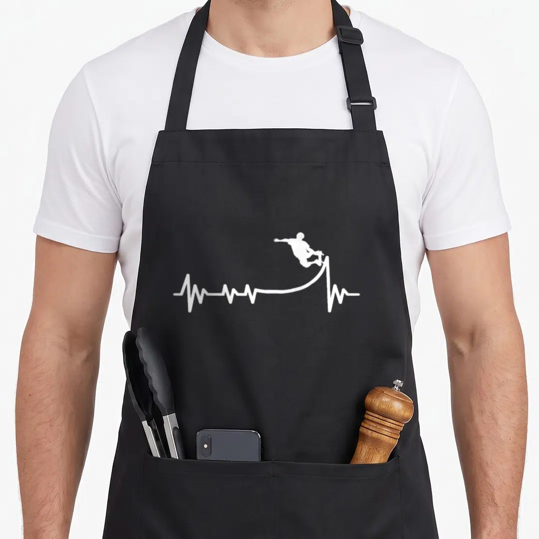 Skaterramp best skater skateboarder accessories stuff apron - White heartbeat line curving into a ramp launching — shown on a black cotton canvas apron against a white background