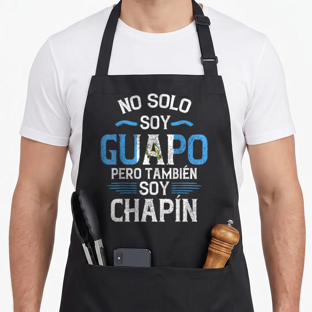 Solo guatemalan aprons - Stacked white and blue text NO SOLO SOY GUAPO PERO TAMBIEN SOY CHAPIN with flag-colored — shown on a black cotton canvas apron against a white background
