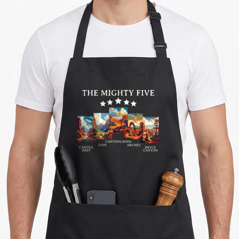 Moab utah apron - Five colorful landscape panels labeled Capitol Reef, Zion, Canyonlands, Arches, and Bryce Canyon — shown on a black cotton canvas apron against a white background