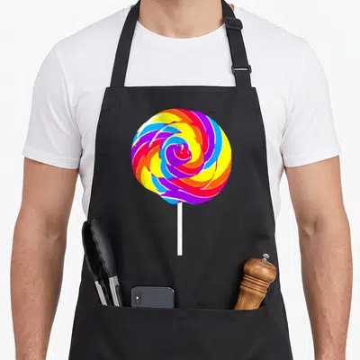 Lollipop funny halloween apron - Cartoon swirl lollipop in red, yellow, blue, purple, and white on white stick — shown on a black cotton canvas apron against a white background