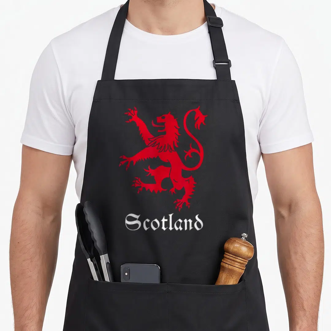 Coat lion apron - Red lion rampant standing above white Scotland text in gothic font — shown on a black cotton canvas apron against a white background