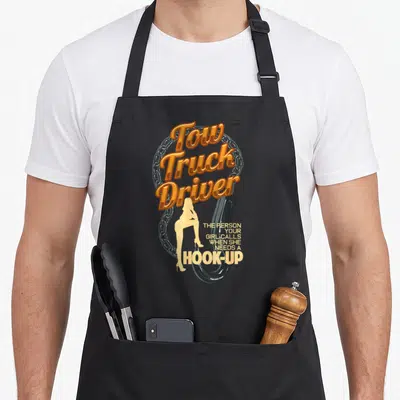 Trucking operator truck apron - Tow Truck Driver text with silver chain, black hook, and woman silhouette — shown on a black cotton canvas apron against a white background