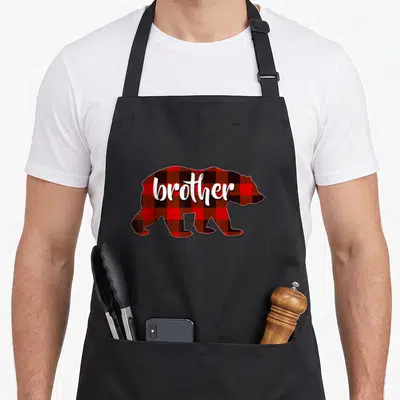 Brother buffalo apron - Red and black plaid bear silhouette with white brother text — shown on a black cotton canvas apron against a white background