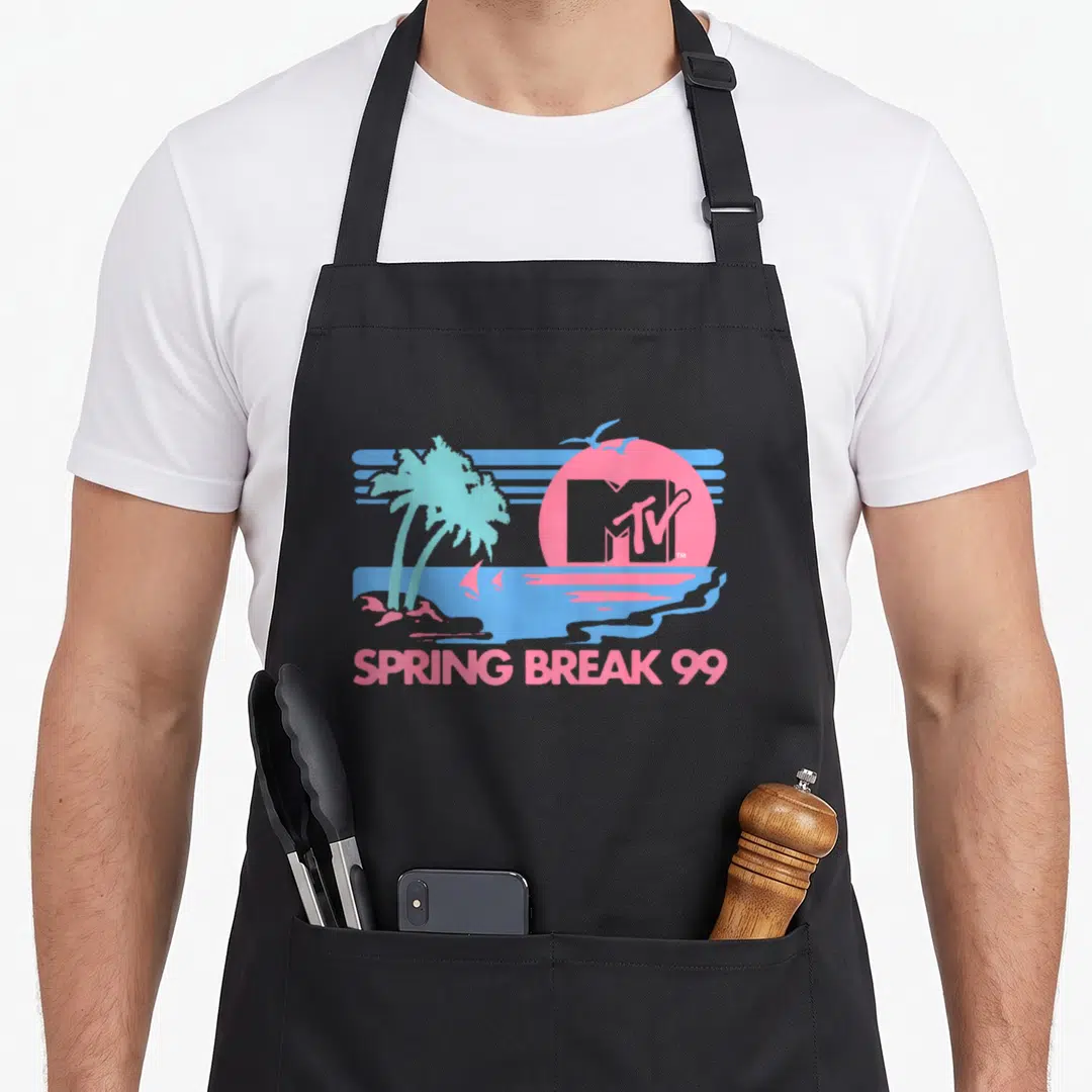 Mtv spring aprons - Retro pink and blue beach scene with MTV logo in sun, palm trees, and SPRING BREAK 99 text — shown on a black cotton canvas apron against a white background