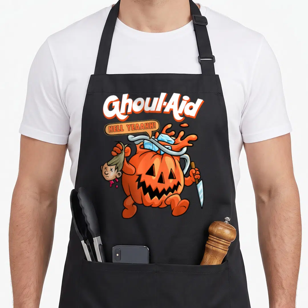 Ghoul halloween kitchen aprons - Cartoon pumpkin monster holding severed head and knife with Ghoul-Aid text — shown on a black cotton canvas apron against a white background