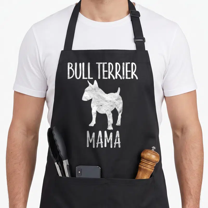 Bull mother's apron - White distressed bull terrier silhouette between BULL TERRIER and MAMA text on black background — shown on a black cotton canvas apron against a white background