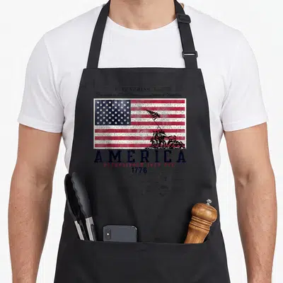 Established 4th of july apron - Declaration of Independence text background with red white blue flag and AMERICA — shown on a black cotton canvas apron against a white background