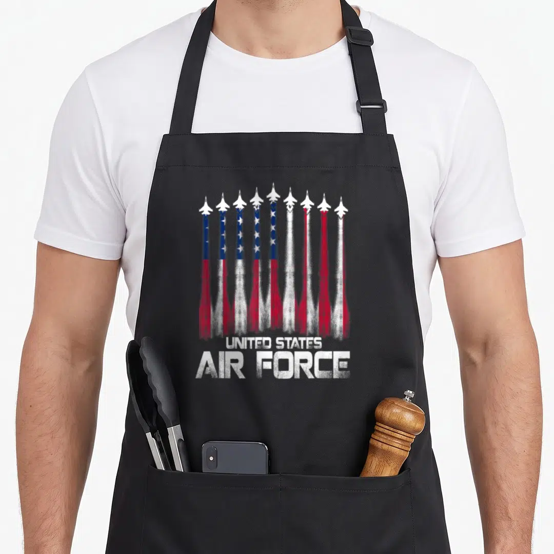 Force 4th of july apron - Nine jets forming distressed flag with United States Air Force text — shown on a black cotton canvas apron against a white background