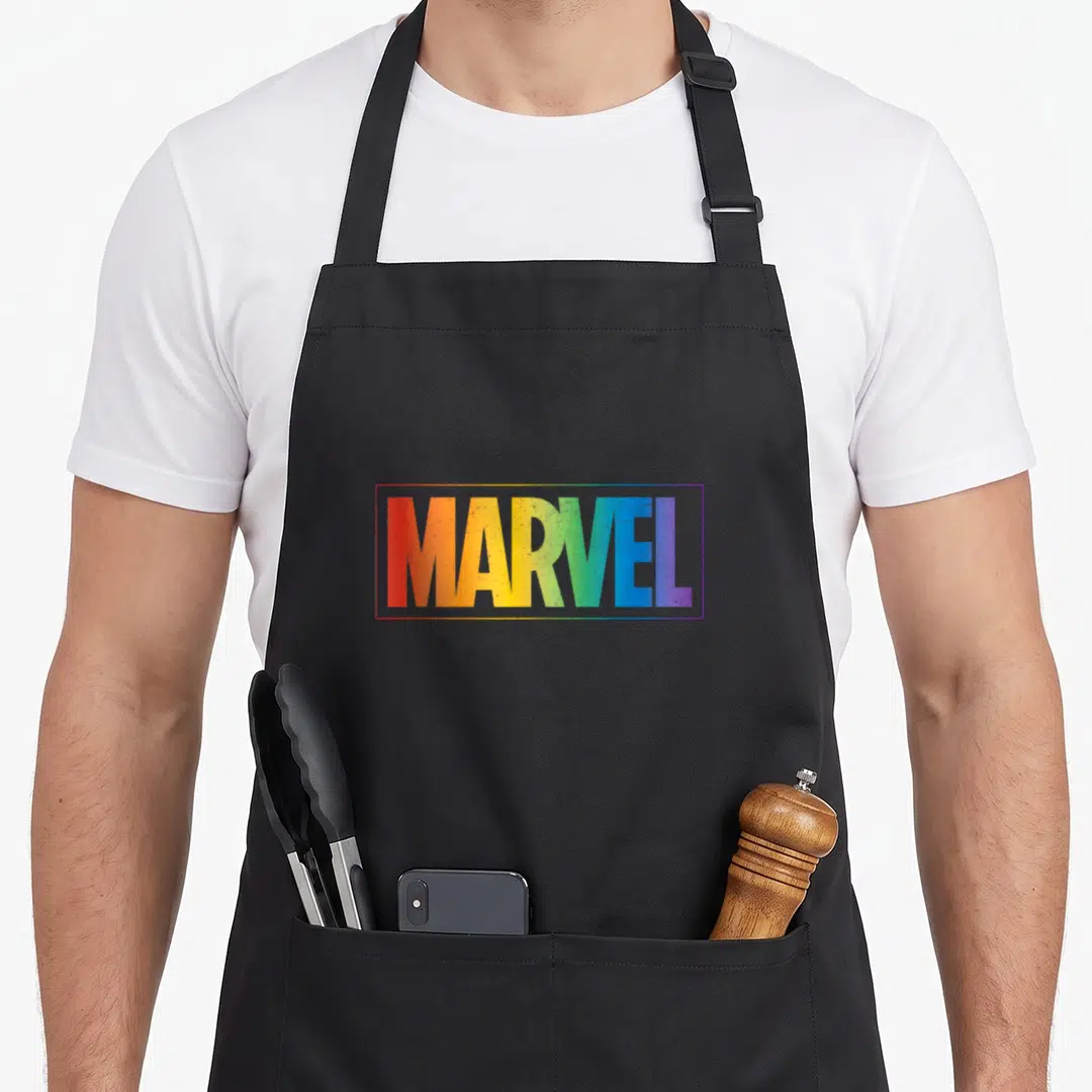 Letter rainbow apron - MARVEL wordmark in rainbow gradient text inside a thin rectangular outline — shown on a black cotton canvas apron against a white background