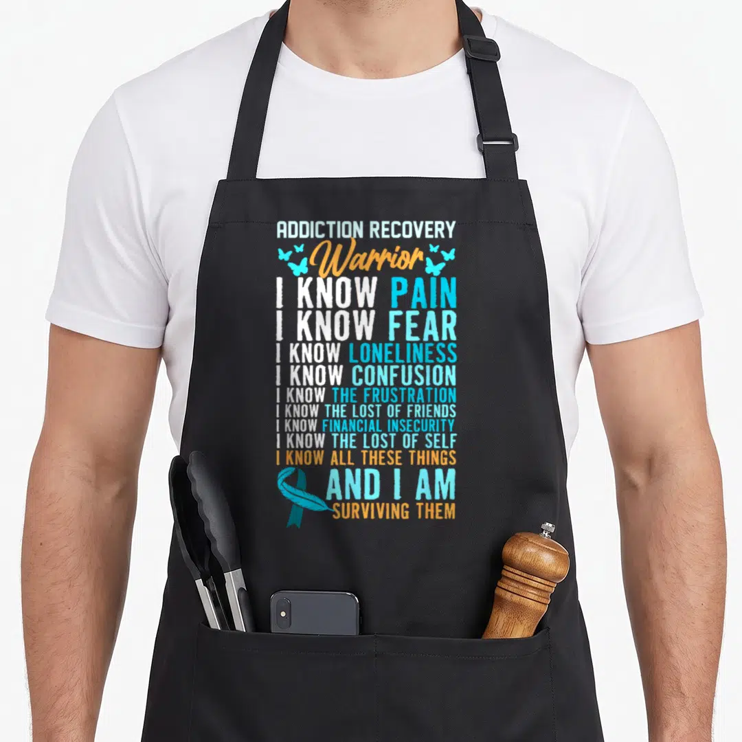 Drug addiction recovery apron - Stacked Warrior text with awareness ribbon and butterflies in white blue orange — shown on a black cotton canvas apron against a white background