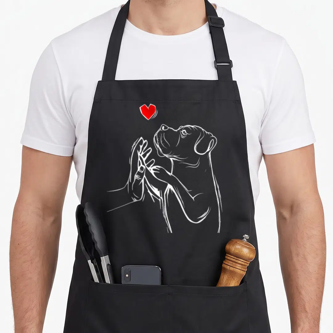 Wifey cane apron - White line art of dog head reaching to hand with red heart above — shown on a black cotton canvas apron against a white background