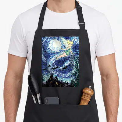 Peter starry night apron - Tinker Bell flying in a swirling blue starry sky above a dark village skyline in watercolor — shown on a black cotton canvas apron against a white background
