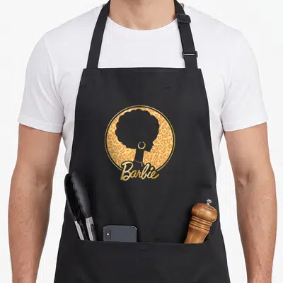 Funny afro leopard apron - Grey afro woman silhouette inside gold leopard circle with Barbie script — shown on a black cotton canvas apron against a white background