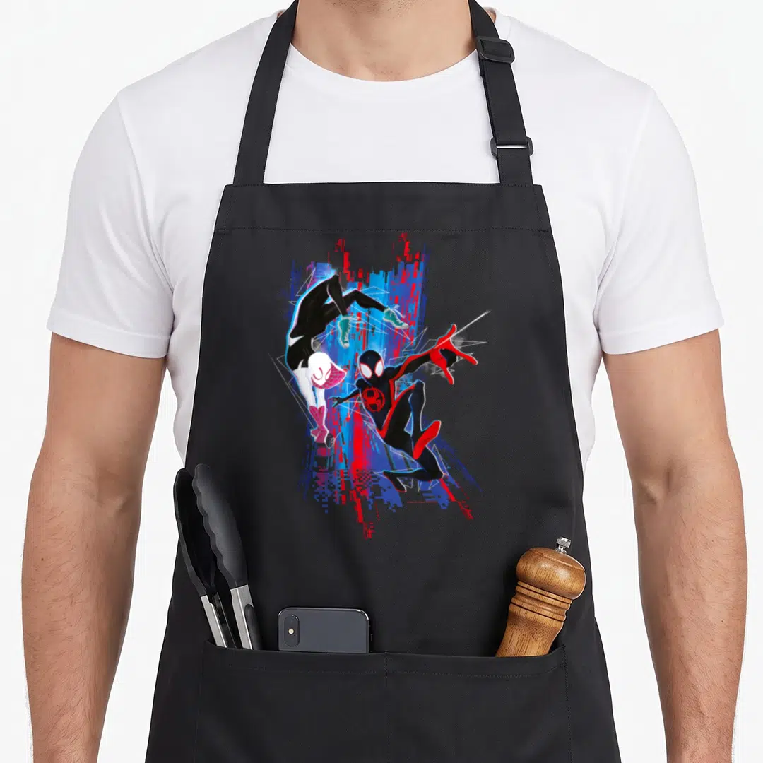 Across spider apron - Miles Morales and companion leaping in black red blue glitch art cartoon style — shown on a black cotton canvas apron against a white background