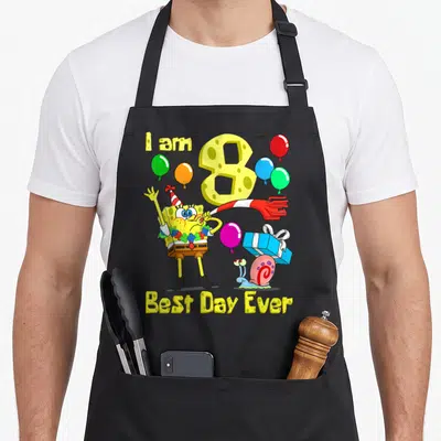 Age birthday party apron - SpongeBob blowing horn near number 8 balloons and Gary snail with gift box — shown on a black cotton canvas apron against a white background