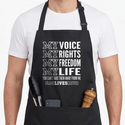 Voice freedom apron - White stacked typography reading My Voice My Rights My Freedom My Life Black Lives Matter — shown on a black cotton canvas apron against a white background