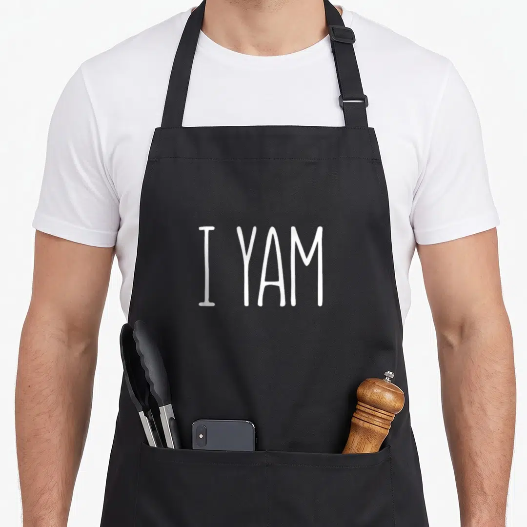 Yam thanksgiving day aprons - White I YAM text in hand-drawn font on grey background — shown on a black cotton canvas apron against a white background