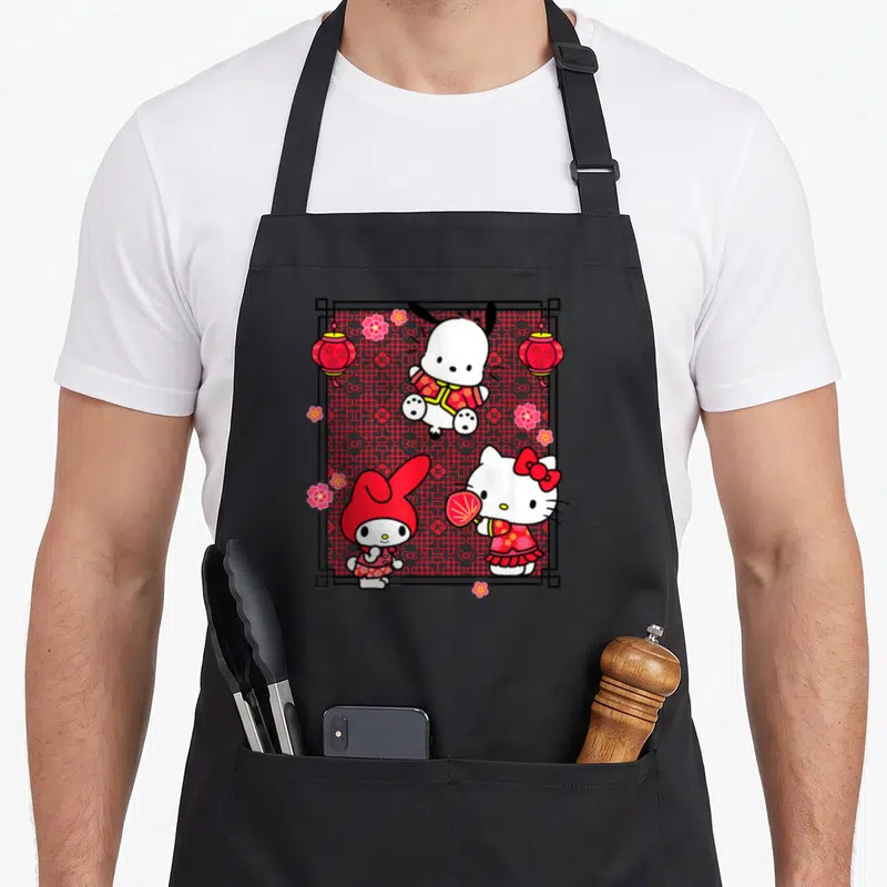 Funny lunar character aprons - Three cartoon characters in red frame with lanterns and flowers — shown on a black cotton canvas apron against a white background