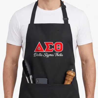 Sigma fraternity apron - Red Delta Sigma Theta Greek letters above white script text on black fabric — shown on a black cotton canvas apron against a white background