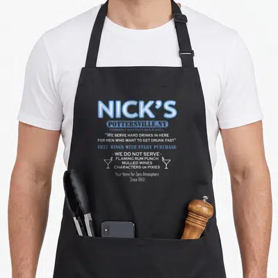 Wonderful baileys apron - Blue and white Nick's Bar sign text with two cocktail glasses and exclusion list — shown on a black cotton canvas apron against a white background