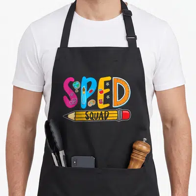 Sped squad personalized teacher aprons - Colorful SPED letters with school icons and a SQUAD pencil graphic — shown on a black cotton canvas apron against a white background