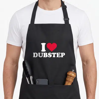 Funny dubstep apron - White I and red heart above centered DUBSTEP text — shown on a black cotton canvas apron against a white background