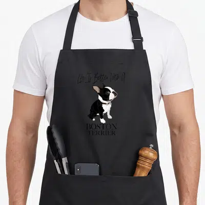 Better boston terrier dog apron - Cartoon Boston Terrier sitting with Life Is Better With A text above and BOSTON — shown on a black cotton canvas apron against a white background