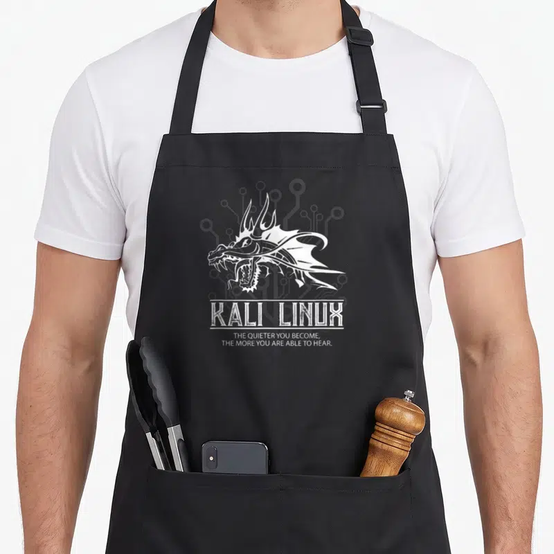 Linux dragon apron - White line-art dragon head above KALI LINUX text and quote — shown on a black cotton canvas apron against a white background