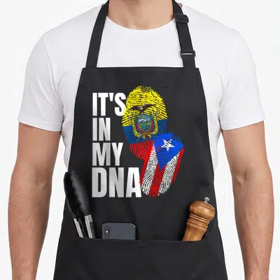 Dna heritage aprons - IT'S IN MY DNA text beside fingerprints filled with Ecuador and Puerto Rico flags — shown on a black cotton canvas apron against a white background