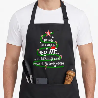 Related i love star apron - Green spiral Christmas tree with red white star Santa hat candy canes and white text — shown on a black cotton canvas apron against a white background